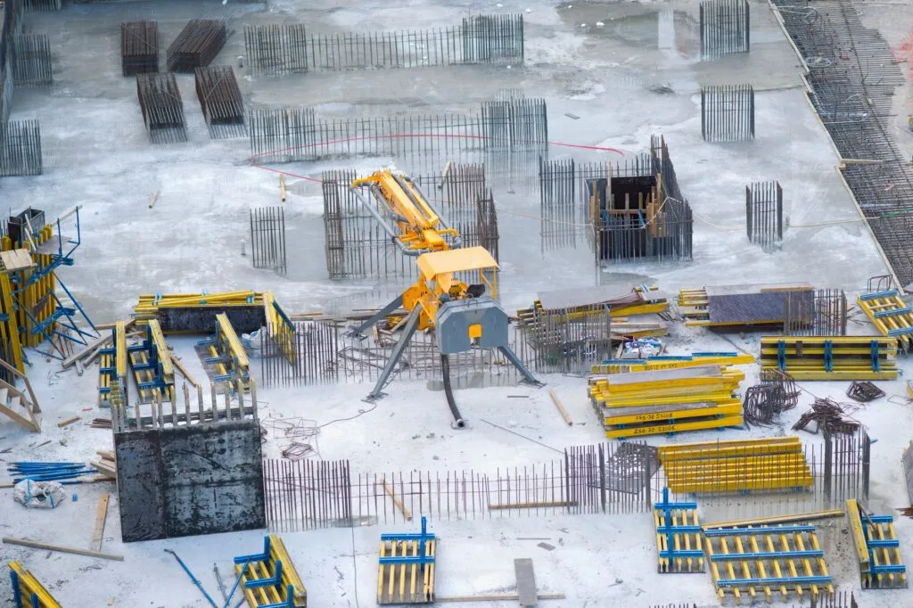 Aerial view of an active construction site with equipment and materials staged