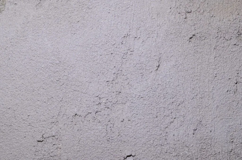 Close-up of a rough-textured gray concrete surface