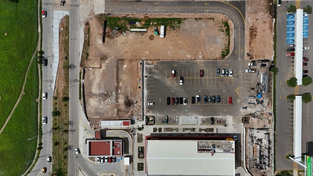Aerial view of commercial concrete flatwork and parking areas at a business site
