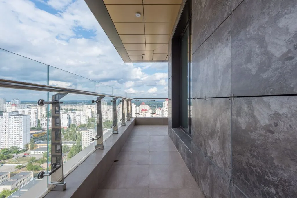Concrete terrace with metal and glass railings at a modern building