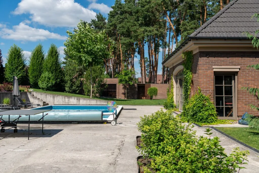 Backyard concrete patio and pool surround at a suburban home